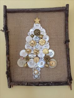 a christmas tree made out of buttons on a piece of burlocked fabric