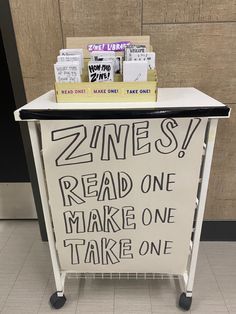 a sign that is sitting on top of a cart with some kind of writing on it