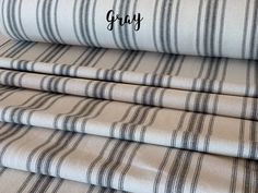 four different striped sheets with the word gray on them in black and white letters that spell out