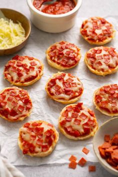 mini pizzas with cheese and tomato sauce are on the table ready to be eaten