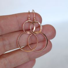 "Rose gold ribbon double hoop earrings. The rose gold has been hand forged and shaped to give them an organic feel. The hammered hoops hang from handmade ball end ear wires. The earrings in the photos have been given a brushed satin finish, but you can also choose shiny at checkout. Classic design with a twist, perfect for every occasion. Earring Length - Approximately 1 3/4\"L **Also available in 14k and 18k yellow gold. To purchase yellow gold go to this listing: https://www.etsy.com/listing/1 Hammered Rose Gold Hoop Earrings Gift, Elegant Hammered Rose Gold Hoop Earrings, Handmade Rose Gold Hoop Earrings For Anniversary, Rose Gold Hammered Small Hoop Earrings, Gold Circle Earrings, Rose Gold Ribbon, Ribbon Earrings, Rose Gold Circle, Hoop Dangle Earrings