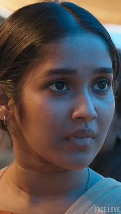 a close up of a person wearing a necklace