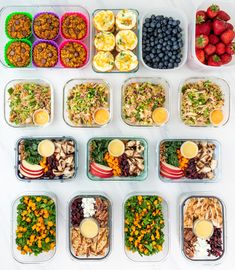 a table topped with plastic containers filled with different types of salads and fruit on top of each other