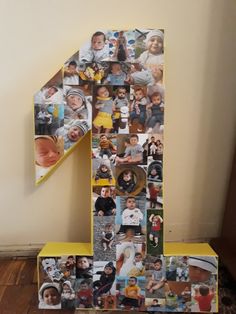 the number one is made up of photos and has been placed in front of a wall