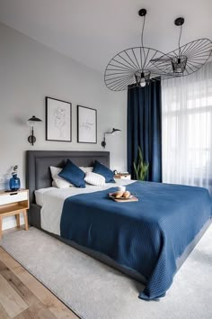 a bedroom with blue and white decor in it