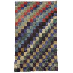 a multicolored rug with squares on the bottom and one diagonal pattern in different colors