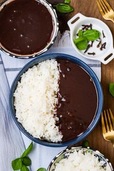 two bowls filled with rice and sauce on top of a table