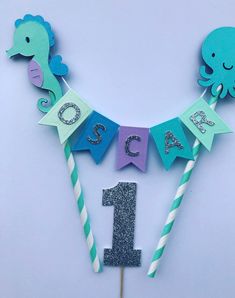 an ocean themed birthday cake topper with the number one on it