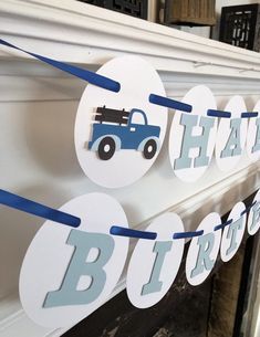 a blue truck birthday banner hanging on the wall