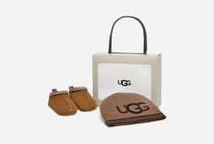 Wrapped in the warmth of UGG®plush, the Tasman is a favorite for all ages. Made from luxurious suede and featuring an easy-to-use hook-and-loop closure, it is paired with a coordinating beanie, ensuring your little one enjoys complete comfort from head to toe. Baby Beanie.Blended Polyester and Nylon knit hat with printed UGG® branding.UGG® Tasman braid accent.Baby Tasman.Suede exterior.UGG® Tasman braid accent.Easy hook-and-loop fastening.10mm UGG®plush, made of 80% repurposed wool and 20% lyoce Baby Uggs, Ugg Tasman, Ugg Slippers, Baby Slippers, Unisex Accessories, Slipper Shoes, Knit Hat, Baby Beanie, Ugg Shoes