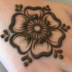 a woman's arm with a hendike on it, decorated with chocolate drops