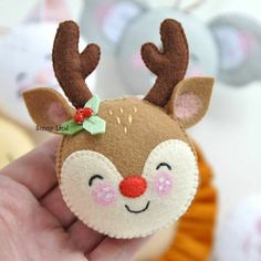 a hand holding a small felt reindeer head