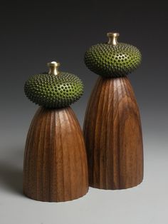 two wooden vases sitting on top of each other