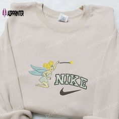 Introducing the magical collaboration between Nike and Tinkerbell! Our Nike x Tinkerbell Cartoon Embroidered Sweatshirt combines the enchanting world of Disney with the iconic style of Nike. Featuring a beautifully embroidered Tinkerbell cartoon on the front, this sweatshirt is a must-have for any Disney lover. The premium quality fabric ensures comfort and durability, while the relaxed fit adds a trendy touch to your wardrobe. Whether you’re heading to the gym or hanging out with friends, Tinkerbell Cartoon, Nike Cartoon, Best Birthday Gift Ideas, Disney Character Shirts, One Piece Shirt, Disney Lover, Iconic Style, Perfect Birthday Gift, Embroidered Sweatshirt