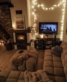 a living room filled with furniture and a flat screen tv sitting on top of a wooden floor