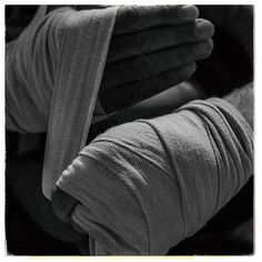 a black and white photo of someone's hands holding something