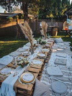 a long table with plates and place settings on it