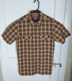 Kuhl Pearl Snap Button Shirt Small Brown Plaid Short Sleeve Outdoor Collar Marks. ____________________________________________________ GENERAL NOTE PLEASE READ: Most items I sell are Pre-owned, pre-loved and pre-worn. This means that these items will shown normal signs of gentle use  that I will try to document as best I can in the following paragraph. Please read the condition legend below to get the most accurate representation of the item you're purchasing. ___________________________________ Brown Fitted Casual Short Sleeve Shirt, Casual Brown Fitted Short Sleeve Shirt, Fitted Brown Short Sleeve Casual Shirt, Brown Outdoor Shirt With Button Closure, Brown Shirt With Button Closure For Outdoor, Brown Tops With Button Closure For Outdoor, Wicked Musical, Brown Plaid, Button Shirt