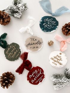 christmas ornaments and pine cones are arranged on a white surface with the names of each holiday event