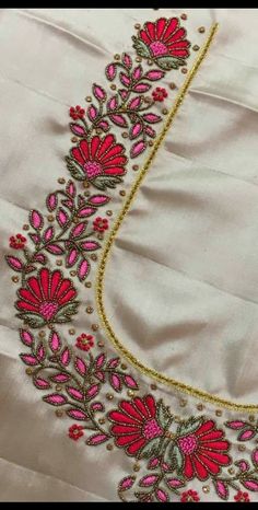 an embroidered piece with pink flowers on it