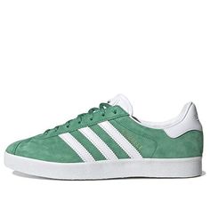 The Adidas Gazelle 85 'Semi Court Green' is a classic sneaker that's perfect for any occasion. Featuring a subtle silhouette, reworked toe overlay, higher lacing and slightly modified 3-stripes, this sneaker is made with a soft and luxurious suede upper. Inspired by the 1985 original, the Gazelle 85 is perfect for casual wear, sports activities and clubbing. The green and white colorway adds a modern touch to this timeless classic. Whether you're running errands or hitting the gym, the Adidas Ga Perfect Sneakers, Adidas Gazelle, Classic Sneakers, Sports Activities, Green And White, Timeless Classic, Running Errands, Casual Wear, Stripes