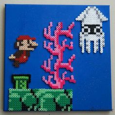 an art piece made out of perler beads on a blue background with animals and plants