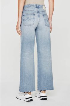 The Saige cropped wide-leg jeans feature a high-rise waist and a roomy fit through the legs, complete with raw hems. • Front Rise: 10 1/4"• Knee Opening: 20 1/4"• Bottom Opening: 21"• Inseam: 27" 97% Cotton, 3% Elastane Cropped Wide Leg Jeans, Clean Aesthetic, Ag Jeans, Sweater Blouse, Denim Pant, Swimwear Accessories, Cropped Jeans, Wide Leg Jeans, Straight Jeans