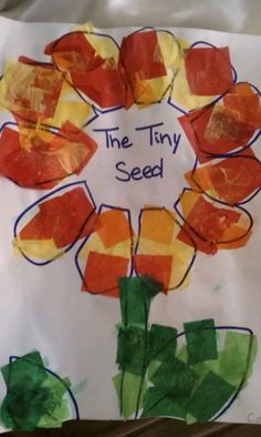 a paper plate with flowers and the words the tiny seed written on it in blue writing