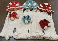 several crocheted hats and booties are laid out on the floor