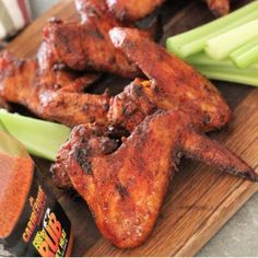 chicken wings and celery on a cutting board