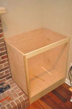 an unfinished cabinet sitting on top of a hard wood floor