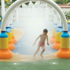 a young boy is playing in the water park