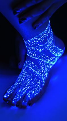 a person with their foot glowing in blue light