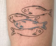 a man's leg with three fish on it and one is drawn in blue ink