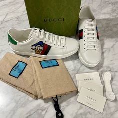 Rare New With Box 100% Authentic Size 38.5 / 8.5 (Please Know What Size You Wear In Gucci Ace Sneakers - Typically Run A Half-Size Larger). Gucci X Disney Donald Duck Ace Sneakers Just Found Your Perfect Pair Of Sneakers? "Oh Boy, Oh Boy, Oh Boy." Gucci's Playful X Disney Donald Duck Ace Sneakers Have Been Rendered In Smooth White Leather With An Embroidered Donald Duck Patch And Web Detail To The Side. We Just Know The Two Of You Will Have Oodles Of Fun Together. Made In Italy White Leather Don Gucci High Top Sneakers, Gucci High Tops, Gucci Ace Sneakers, Disney Donald Duck, Red Trainers, Web Detail, Denim Sneakers, Vintage Sneakers, Air Jordan Sneakers