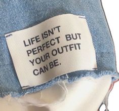 a label on the back of a pair of jeans that says, life isn't perfect but your outfit can be