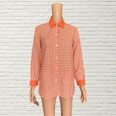 Vintage 60s Orange & White Gingham Blouse  1960s cotton blouse with light orange and white gingham plaid print  collared neckline  pockets  flaws as pictured  Measurements: Length: 27.5" Pit to pit: 18" Shoulder to shoulder: 15" Spring Gingham Tops With Pockets, Collared Plaid Blouse For Daywear, Vintage Gingham Blouse For Spring, Gingham Collared Blouse For Work, Spring Vintage Gingham Blouse, Vintage Gingham Cotton Blouse, Retro Spring Shirt With Placket, Collared Gingham Shirt For Fall, Retro Plaid Shirt For Spring