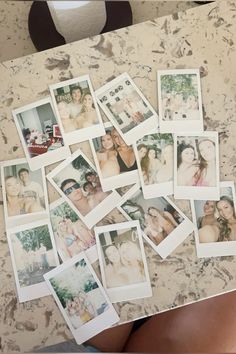 many polaroid photos are arranged on a table with one woman's stomach visible