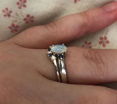 "A unique oval-shaped faceted rainbow moonstone engagement ring set accented with 2 petite genuine blue sapphires complemented with a matching contour wedding band featuring genuine blue and white sapphires handcrafted in sterling silver. Wrapped in a box ready for gift-giving.(r-egt-9) Instagram Video --------------- https://instagram.com/p/Bl3qWYXFgUA/ Can be custom made in any material and gemstones Center stone measure 7mm x 6mm Side Stone measures 2.2mm ----> Please note there is an addi White Oval Sapphire Ring, White Gold Sapphire Ring With Gemstone Accents For Wedding, Wedding White Gold Sapphire Ring With Gemstone Accents, Oval Sapphire Birthstone Ring For Wedding, Oval Sapphire Wedding Birthstone Ring, Silver Oval Cabochon Sapphire Ring For Wedding, Wedding Sapphire Ring With Gemstone Accents In Sterling Silver, Silver Oval Cabochon Sapphire Wedding Ring, Elegant Sapphire Moonstone Ring In Oval Shape