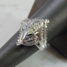 a diamond ring sitting on top of a black piece of cloth