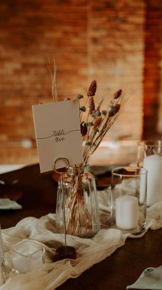 the table is set with candles and place cards