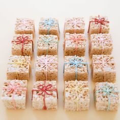 small square cookies with bows tied around them