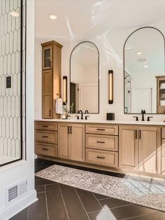 a large bathroom with double sinks and mirrors