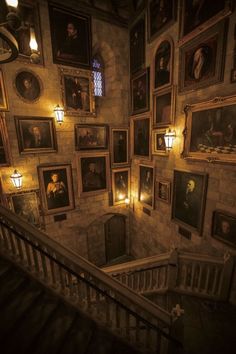 an old building with paintings on the walls and staircase leading up to it's second floor