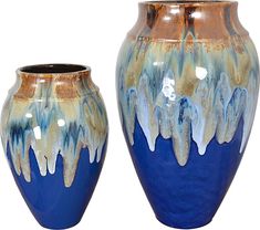 two blue and gold vases sitting next to each other on a white background,