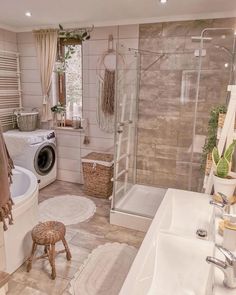 a bathroom with a washer and dryer next to a tub in the corner