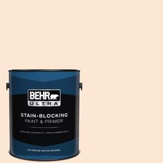 a gallon of behr ultra stain blocking paint and primer on a beige background