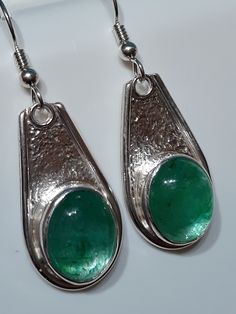 One of a kind, handcrafted, Zambian Emerald and sterling silver earrings.  Each earring measures about 43mm X 15mm. Unique Green Teardrop Earrings For Gift, Artisan Silver Teardrop Earrings, Unique Drop Earrings For Pierced Ears, Silver Drop Artisan Earrings, Artisan Silver Drop Earrings, Artisan Silver Long Drop Earrings, Artisan Sterling Silver Nickel-free Teardrop Earrings, Unique Nickel Free Long Drop Earrings, Artistic Sterling Silver Teardrop Earrings