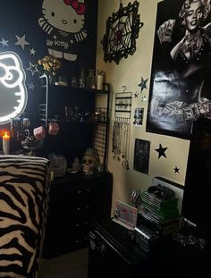 a bedroom decorated in black and white with hello kitty pictures on the wall