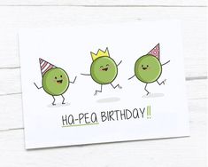 three peas wearing party hats and one has a happy birthday card in front of them